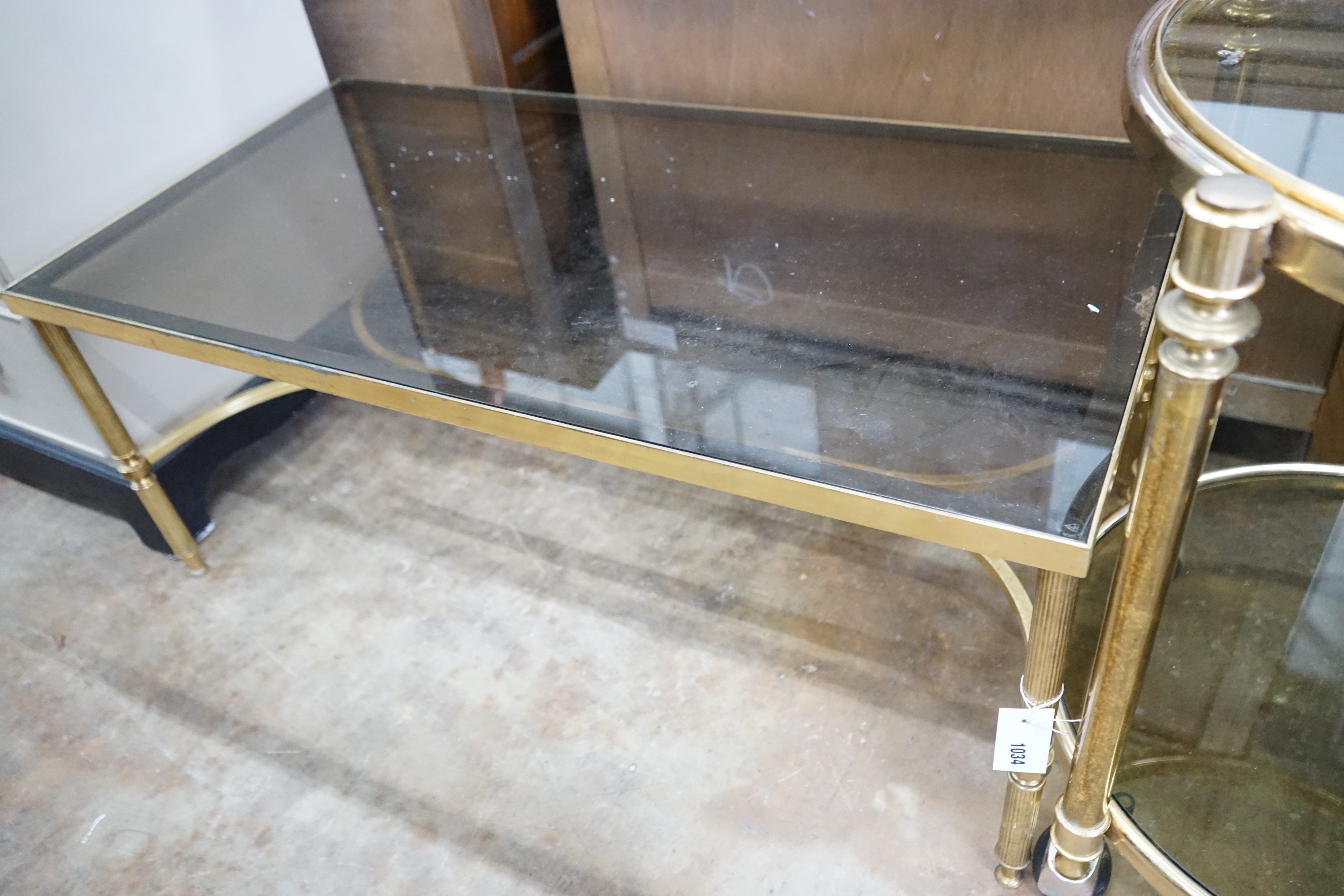 A brass and smoked glass rectangular coffee table, width 99cm, depth 51cm, height 42cm